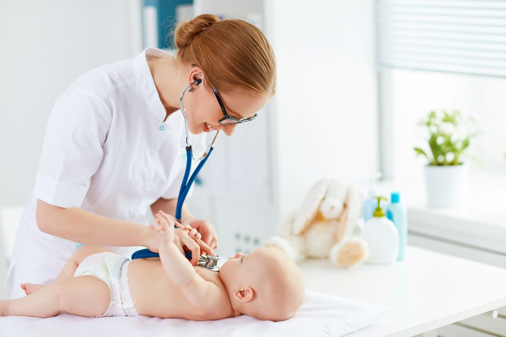nurse measuring baby on table with stethoscope growth chart child development