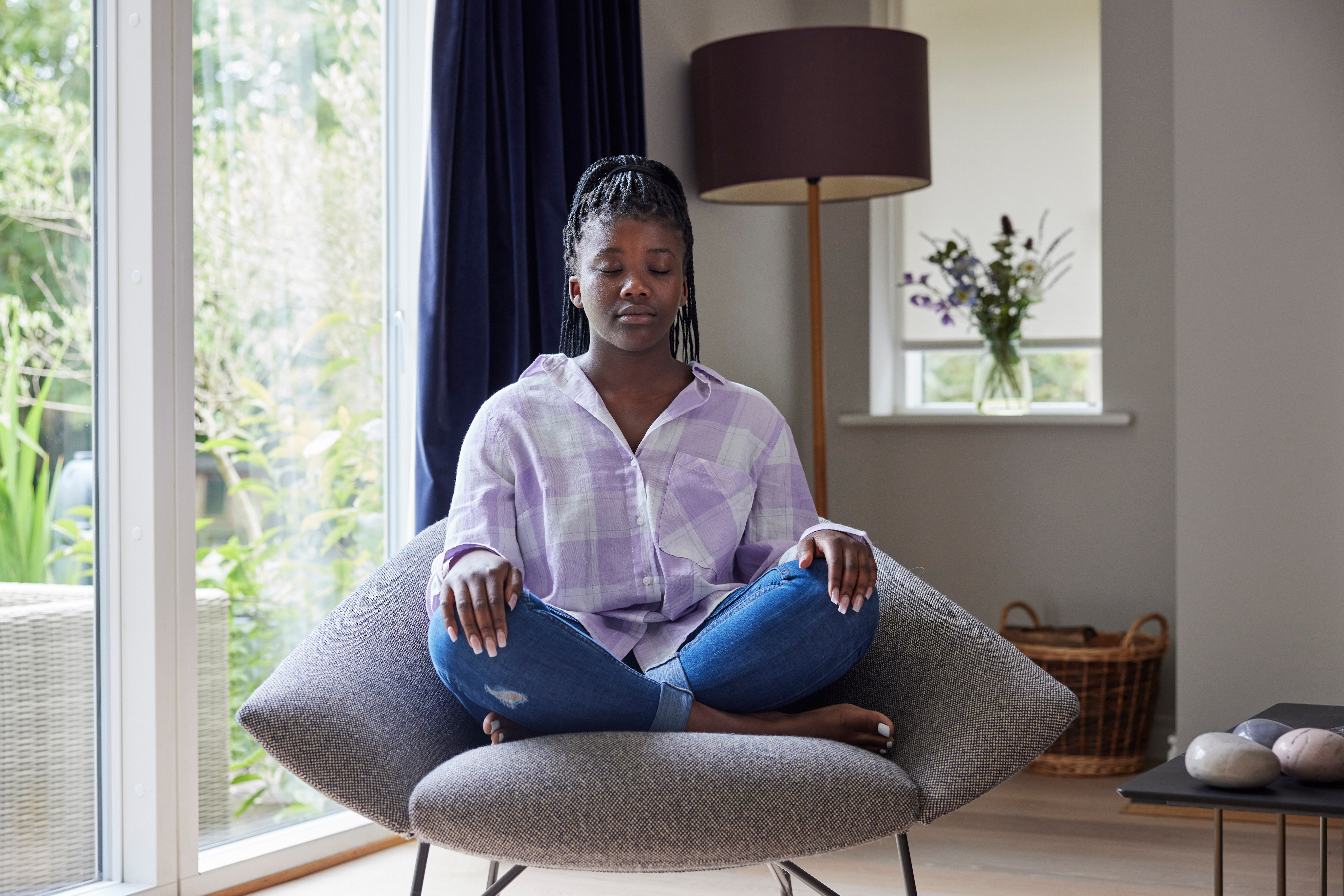 teen girl sitting in chair practicing mindfulness peace patience calm